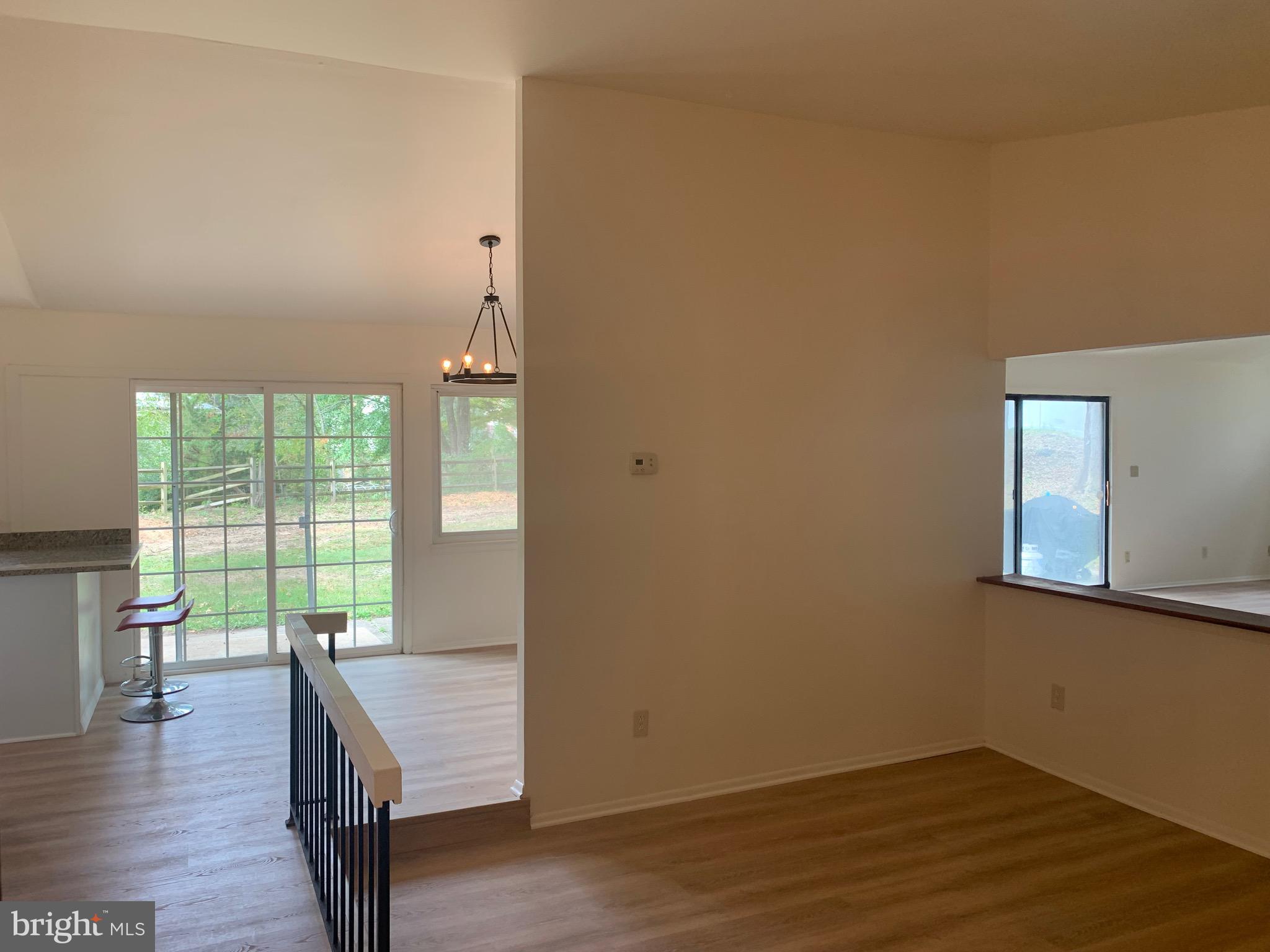 5656 Shadow Fall Terrace Columbia, MD 21045 - Photo 1 of 41 an empty room with wooden floor and windows