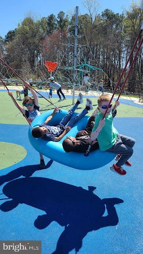 5656 Shadow Fall Terrace Columbia, MD 21045 - Photo 40 of 41 a backyard of a house with table and chairs