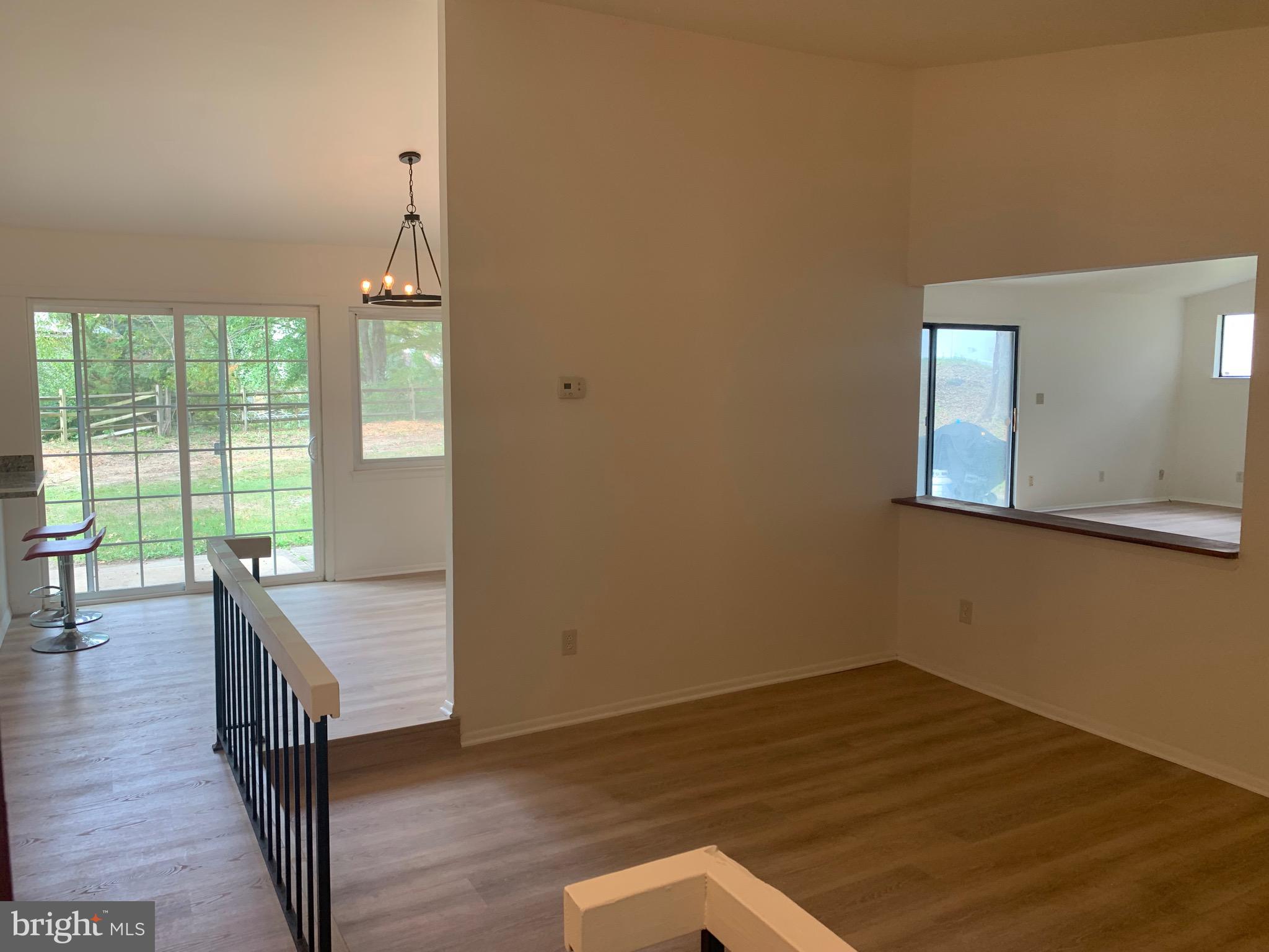 5656 Shadow Fall Terrace Columbia, MD 21045 - Photo 6 of 41 a view of a room with wooden floor and windows