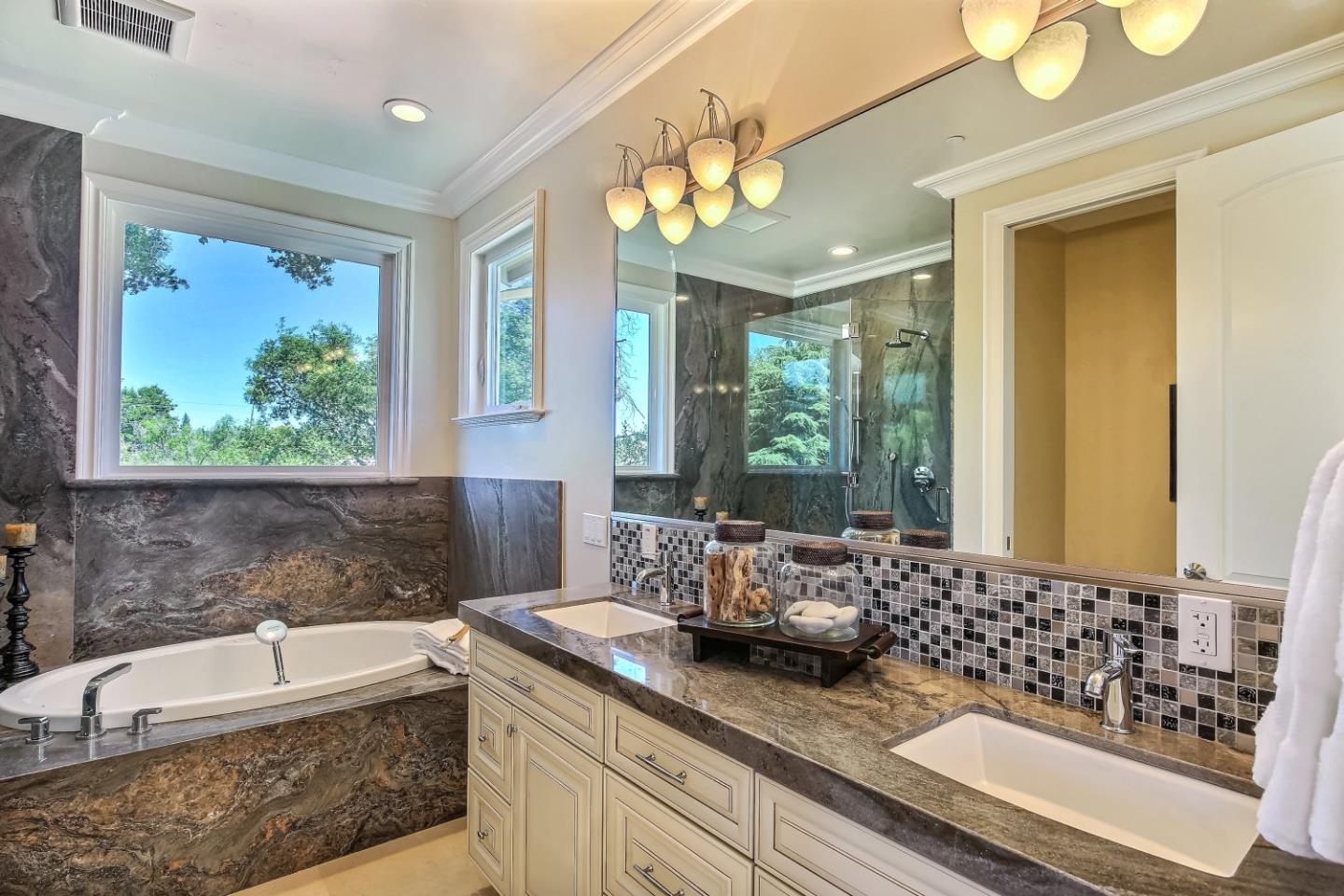 10438 North Stelling Road Cupertino, CA 95014 - Photo 13 of 22 a bathroom with a granite countertop sink a large mirror and a bathtub