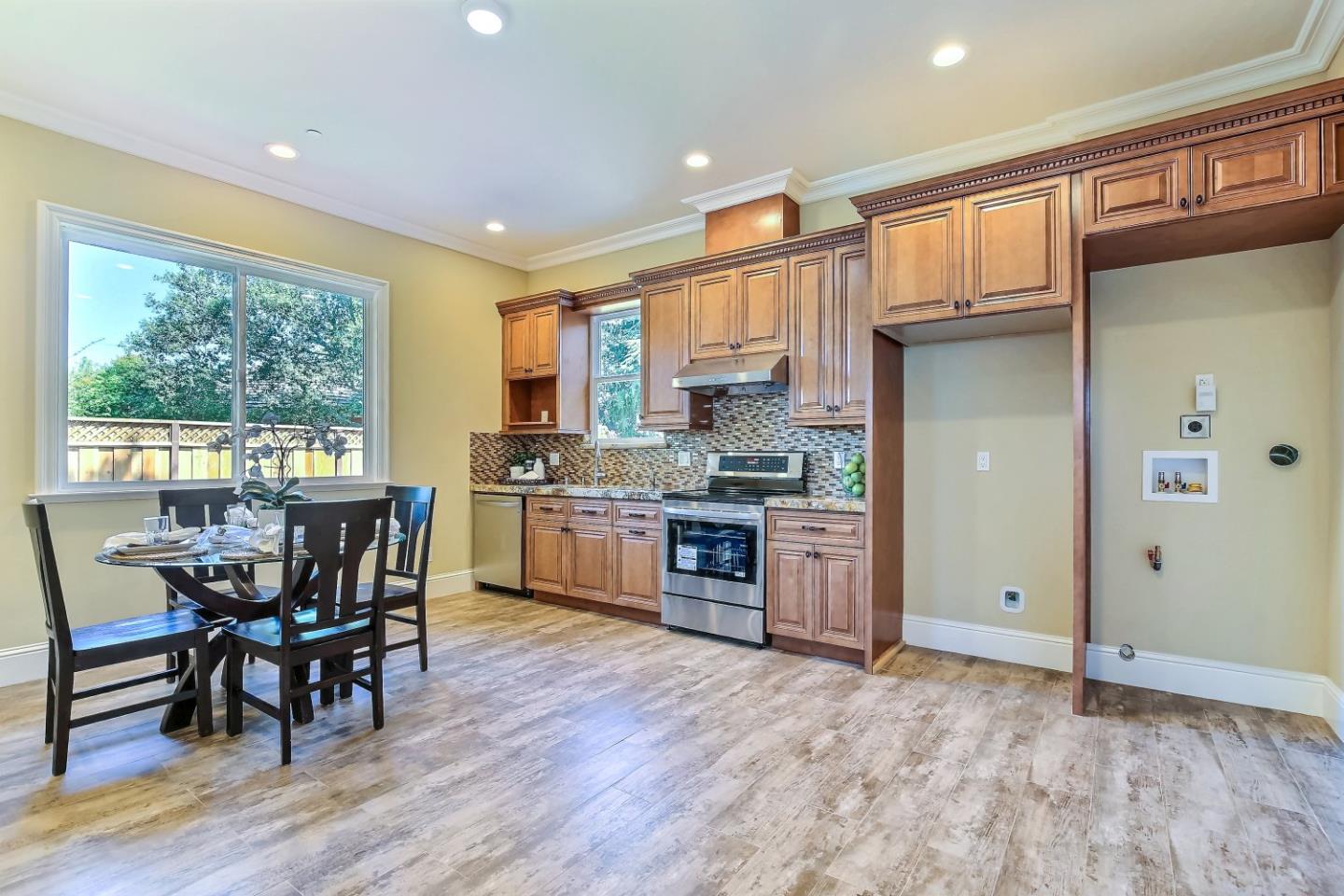 10438 North Stelling Road Cupertino, CA 95014 - Photo 17 of 22 a kitchen with a table chairs refrigerator and cabinets