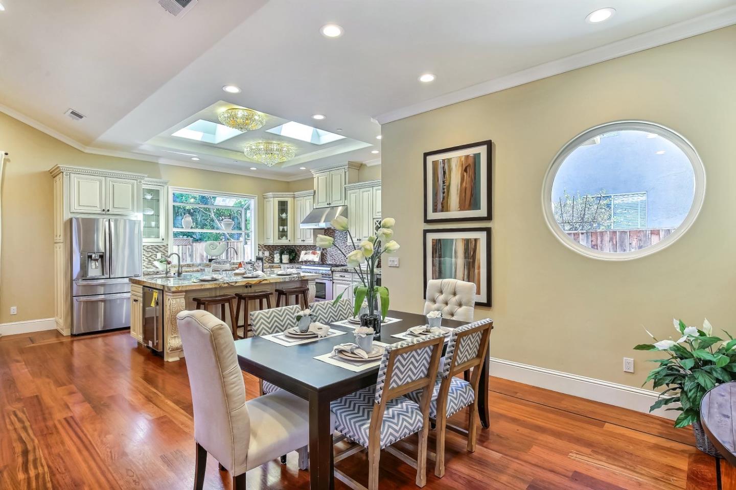 10438 North Stelling Road Cupertino, CA 95014 - Photo 8 of 22 a dining room with wooden floor a chandelier a wooden table and chairs
