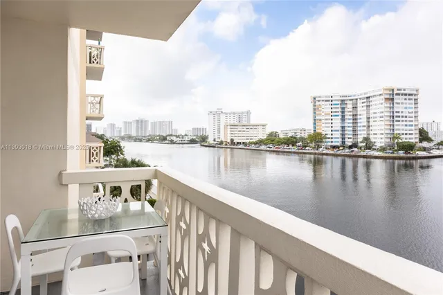 a balcony with wooden floor and lake view