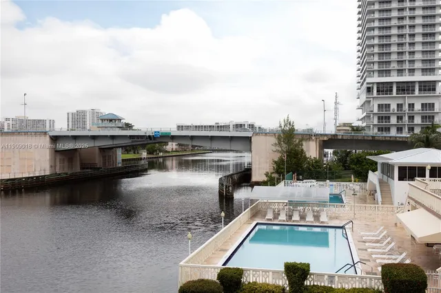 a view of a swimming pool with outdoor seating
