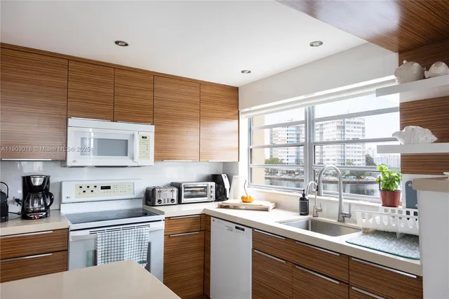 a kitchen with a sink cabinets and window