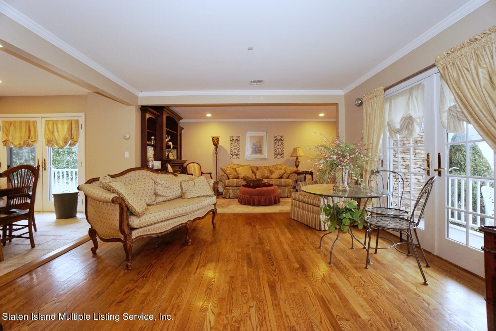 65 Lander Avenue Staten Island, NY 10314 - Photo 11 of 53 a living room with furniture and a wooden floor