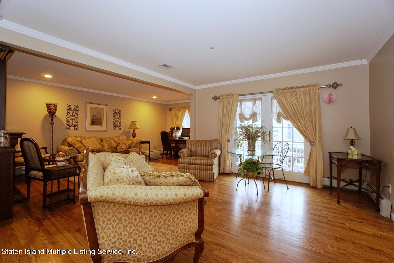 65 Lander Avenue Staten Island, NY 10314 - Photo 12 of 53 a living room with furniture wooden floor and a large window
