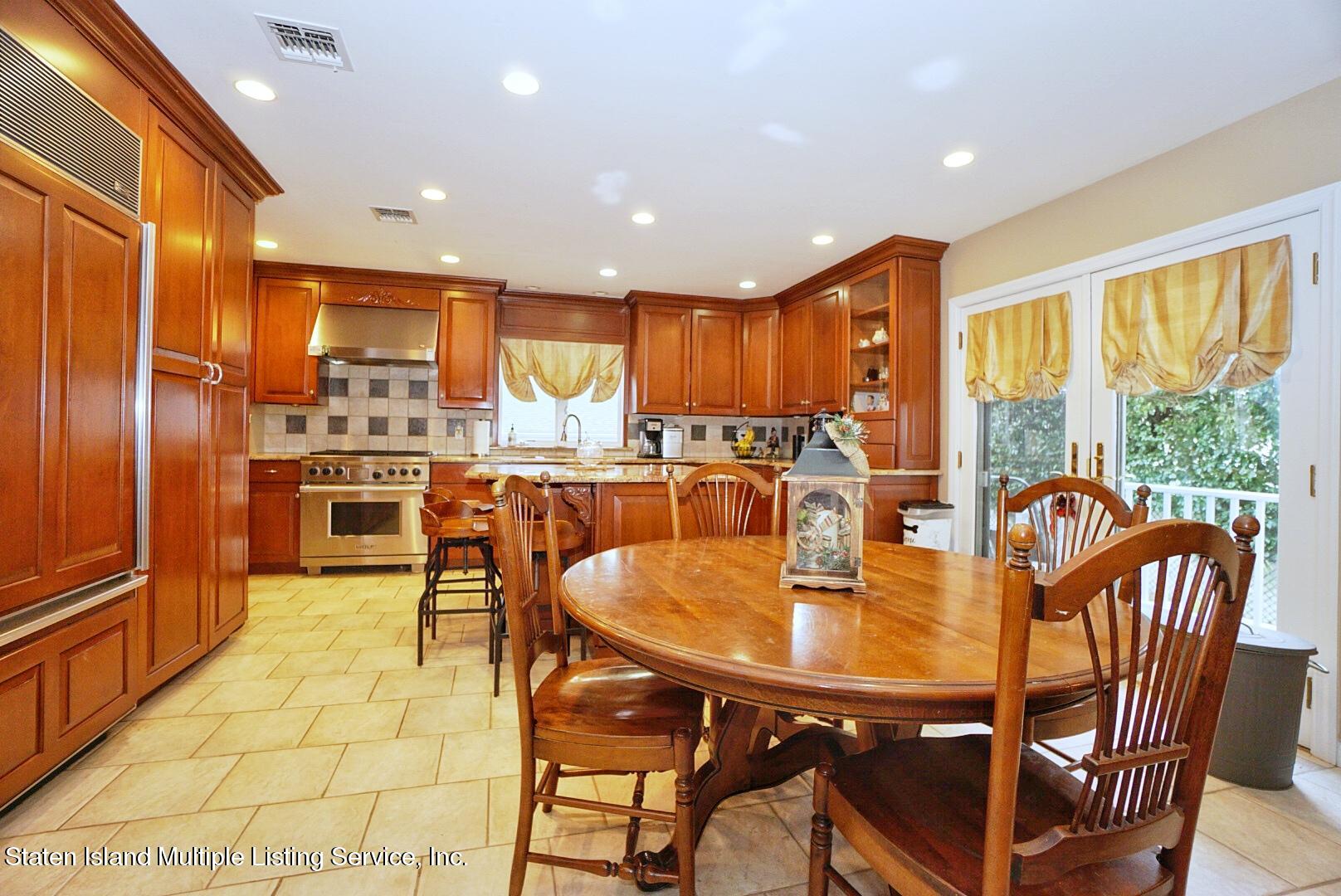 65 Lander Avenue Staten Island, NY 10314 - Photo 15 of 53 a view of a dining room with furniture window and outside view