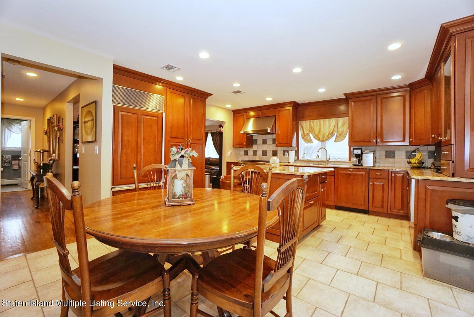 65 Lander Avenue Staten Island, NY 10314 - Photo 16 of 53 a dining hall with stainless steel appliances a dining table and chairs