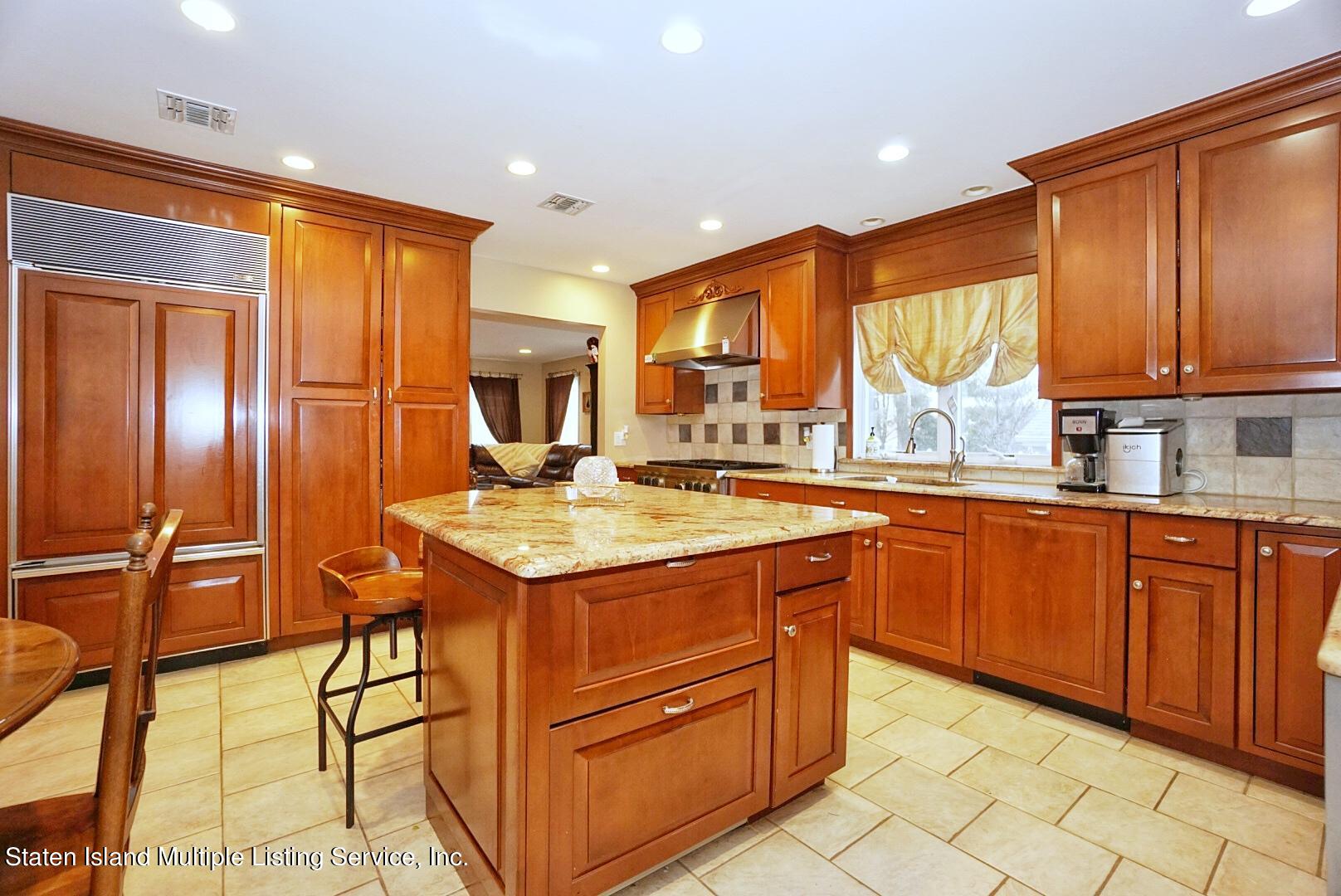 65 Lander Avenue Staten Island, NY 10314 - Photo 18 of 53 a kitchen with stainless steel appliances granite countertop wooden cabinets a sink and a stove