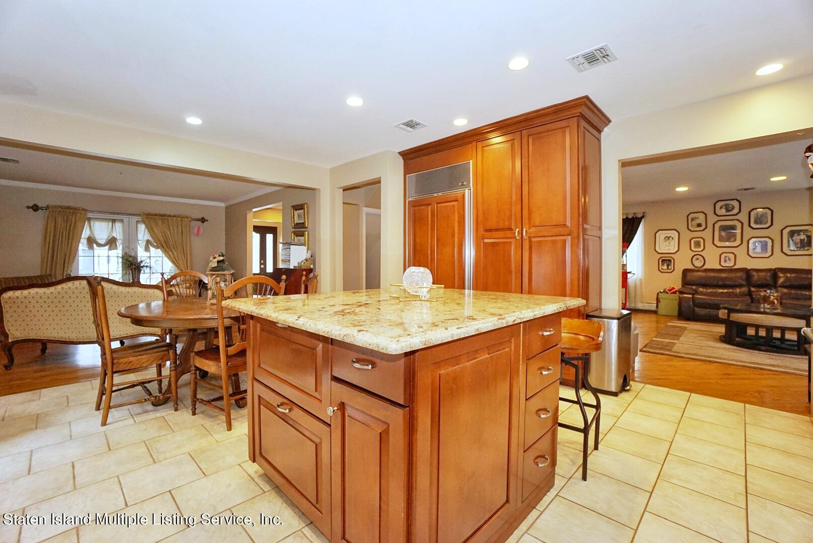65 Lander Avenue Staten Island, NY 10314 - Photo 19 of 53 a kitchen with stainless steel appliances granite countertop a sink and a refrigerator