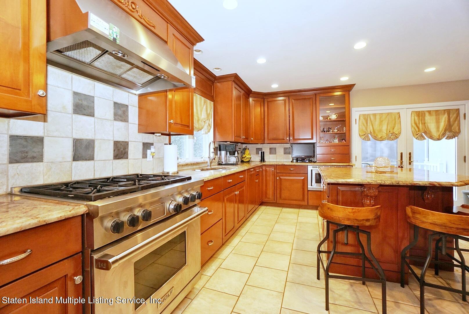 65 Lander Avenue Staten Island, NY 10314 - Photo 20 of 53 a kitchen with stainless steel appliances granite countertop a stove a sink and a refrigerator