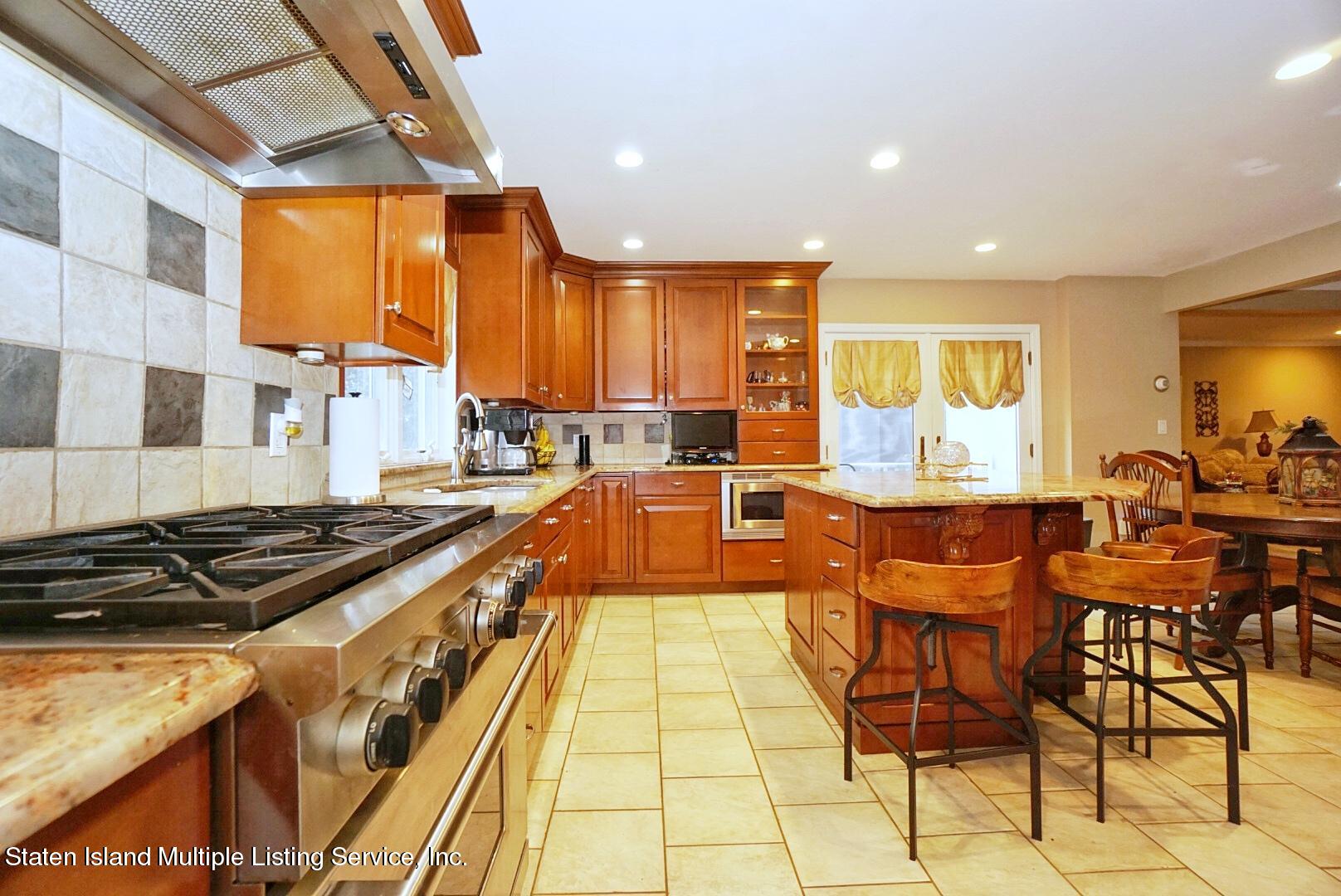 65 Lander Avenue Staten Island, NY 10314 - Photo 21 of 53 a kitchen with stainless steel appliances granite countertop a stove a sink and a refrigerator