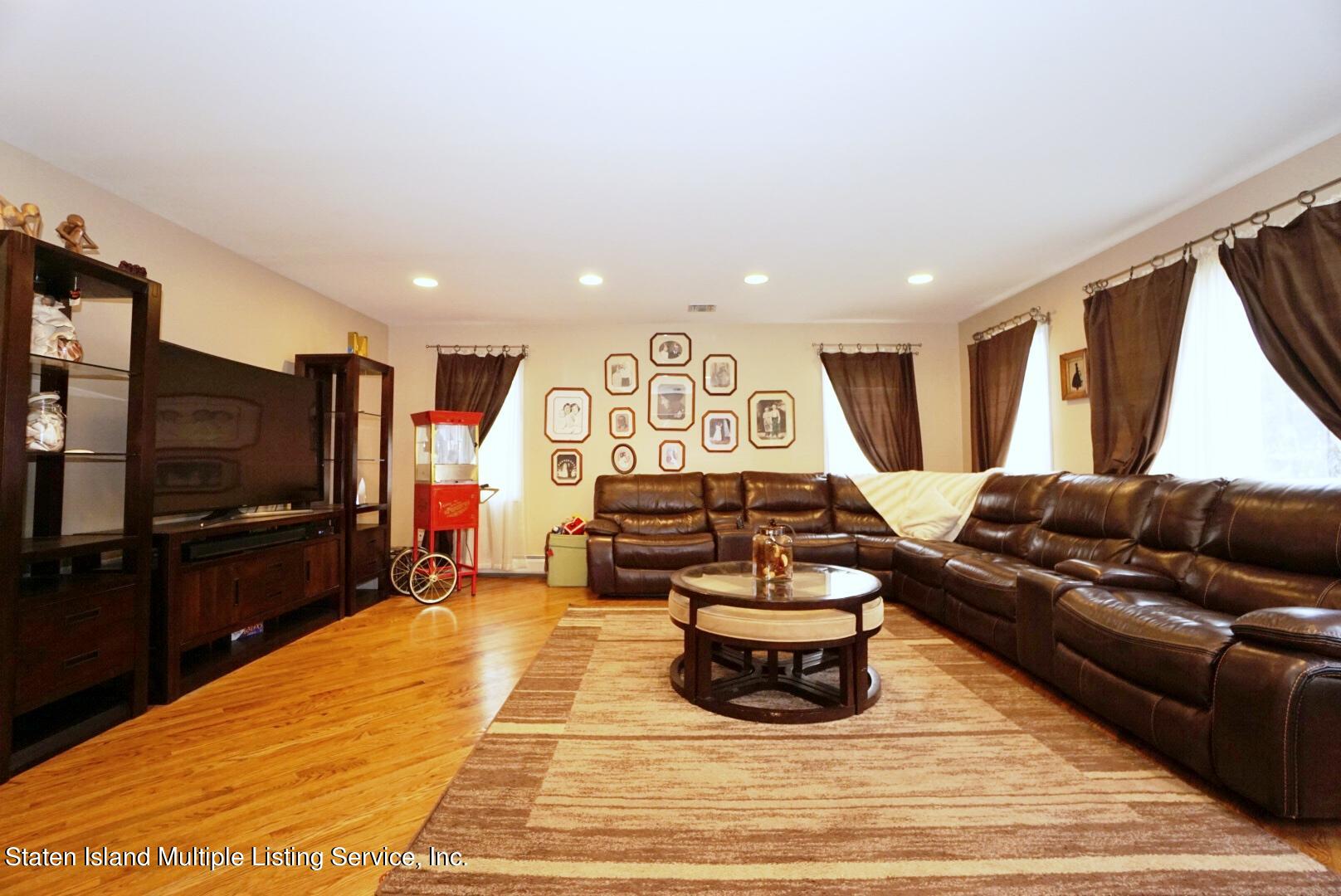 65 Lander Avenue Staten Island, NY 10314 - Photo 23 of 53 a living room with furniture and a flat screen tv