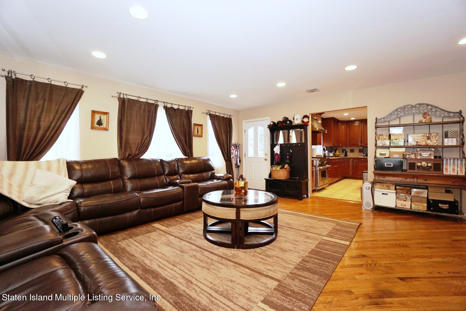 65 Lander Avenue Staten Island, NY 10314 - Photo 24 of 53 a living room with furniture and a flat screen tv