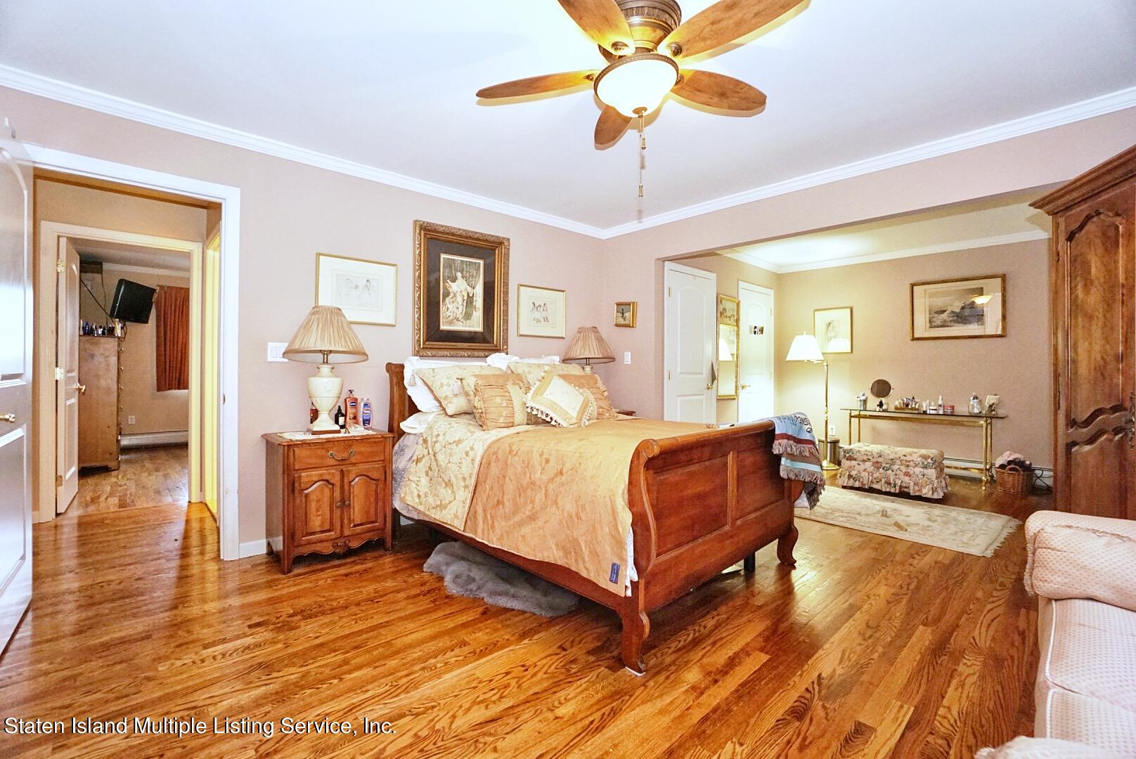 65 Lander Avenue Staten Island, NY 10314 - Photo 28 of 53 a bedroom with a bed and a chandelier