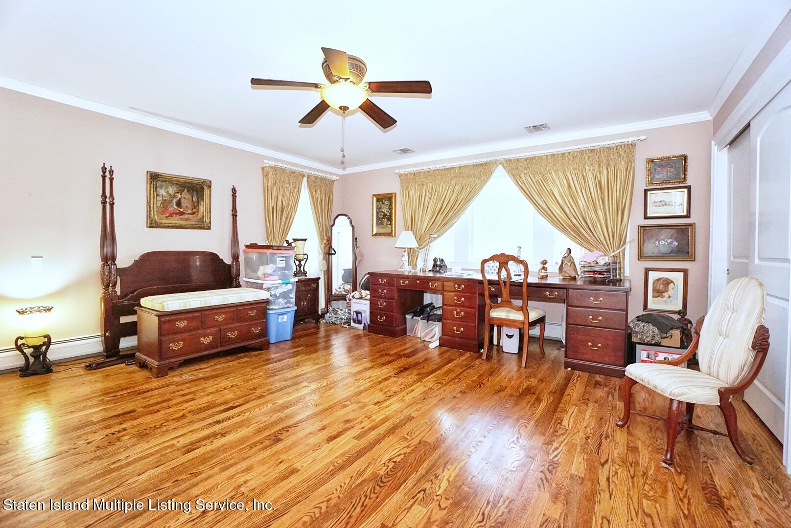 65 Lander Avenue Staten Island, NY 10314 - Photo 34 of 53 a living room with furniture and a large window