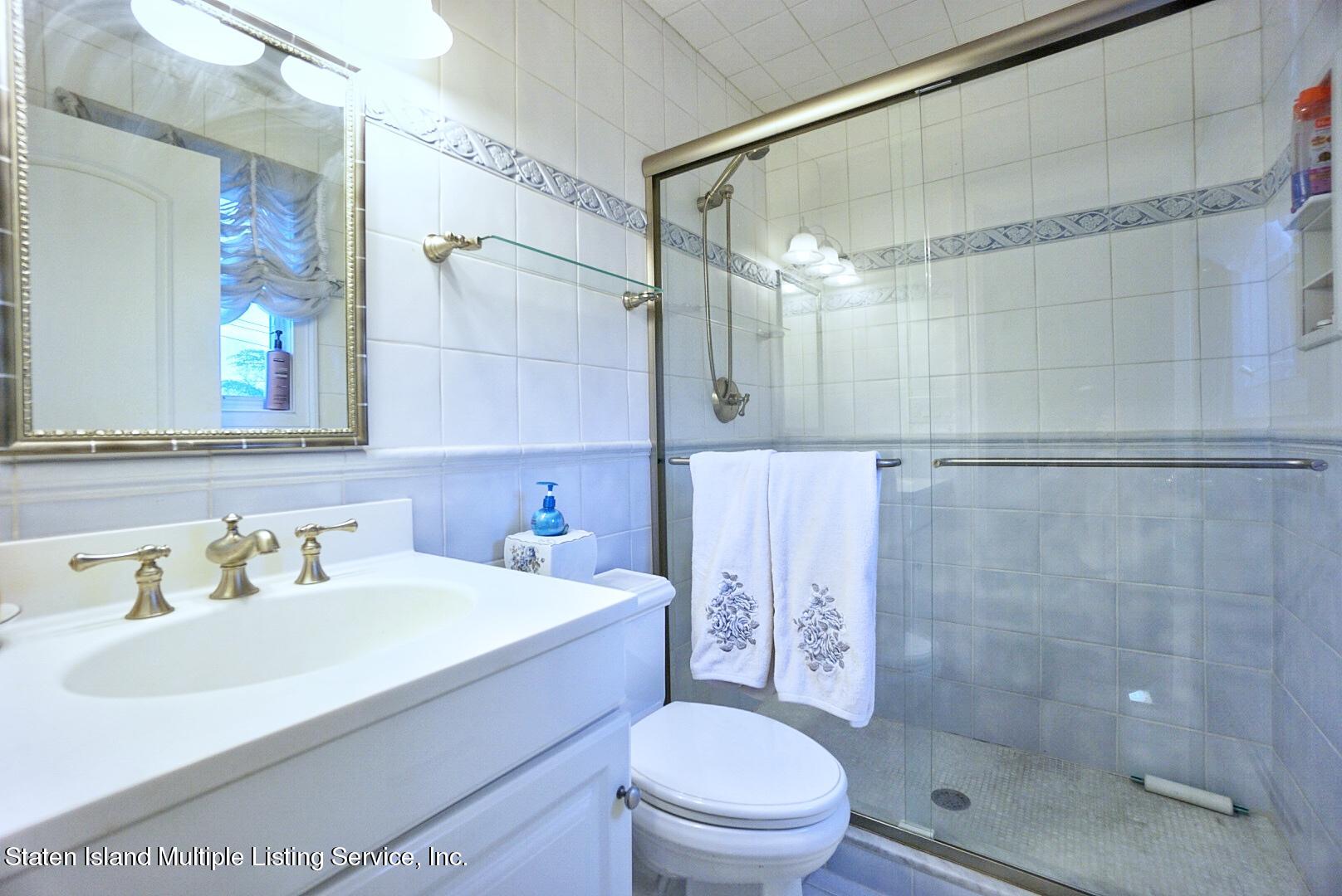 65 Lander Avenue Staten Island, NY 10314 - Photo 35 of 53 a bathroom with a sink a toilet and shower