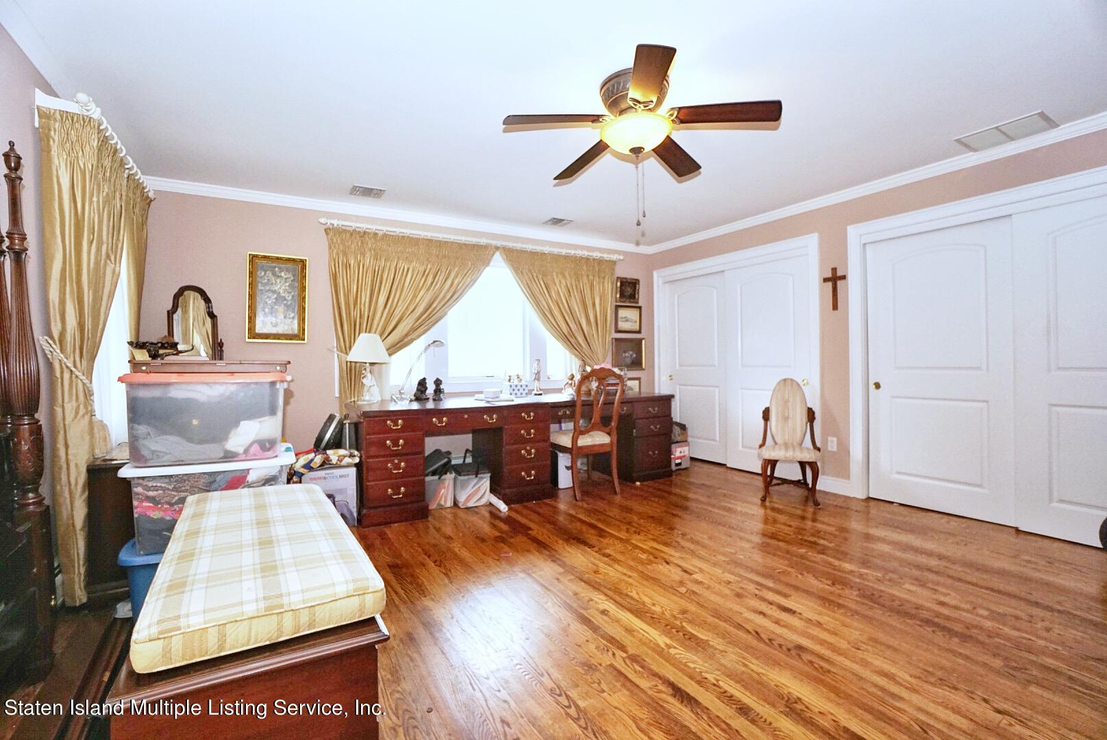 65 Lander Avenue Staten Island, NY 10314 - Photo 36 of 53 a living room with furniture and a wooden floor