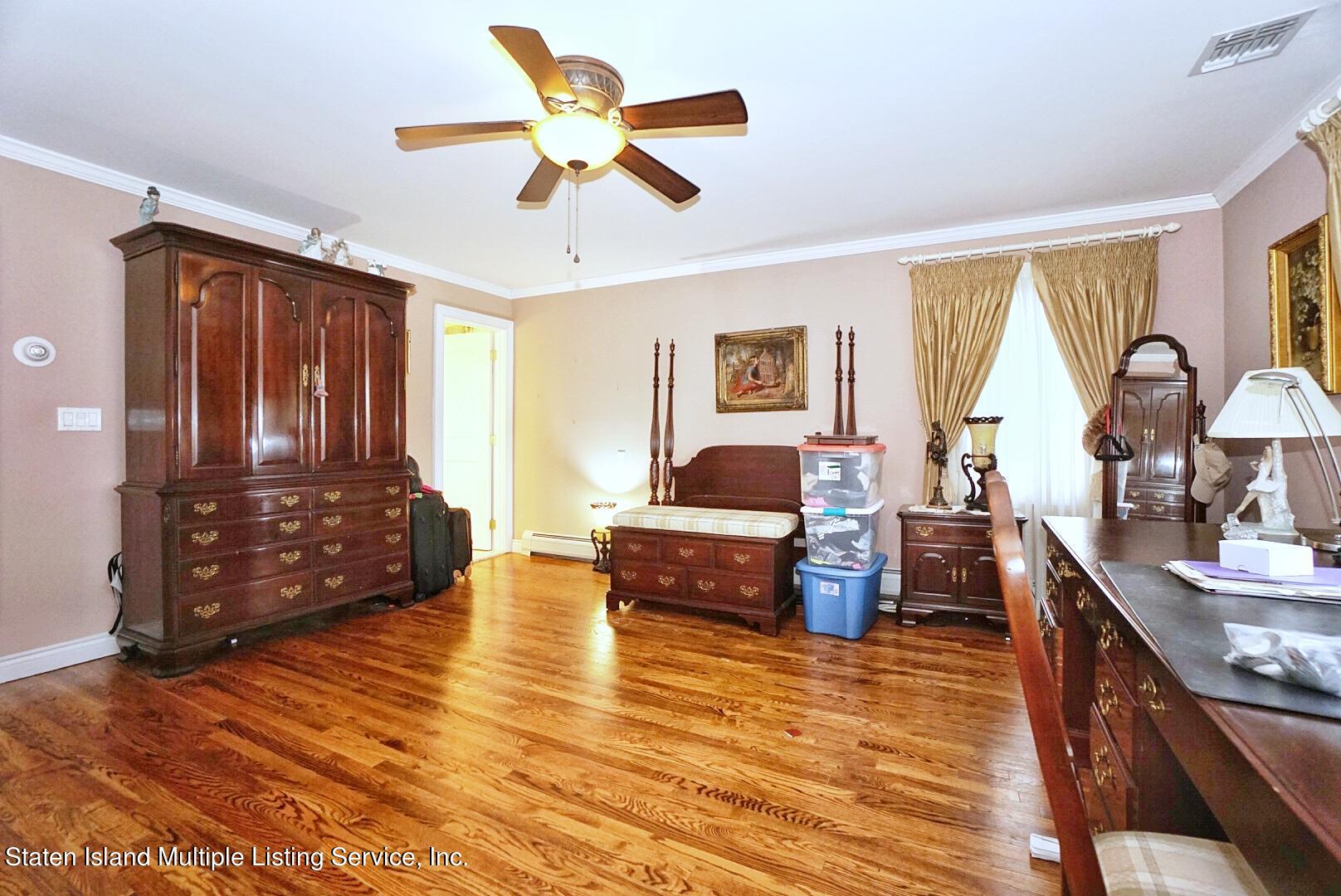 65 Lander Avenue Staten Island, NY 10314 - Photo 37 of 53 a view of living room kitchen with furniture and wooden floor
