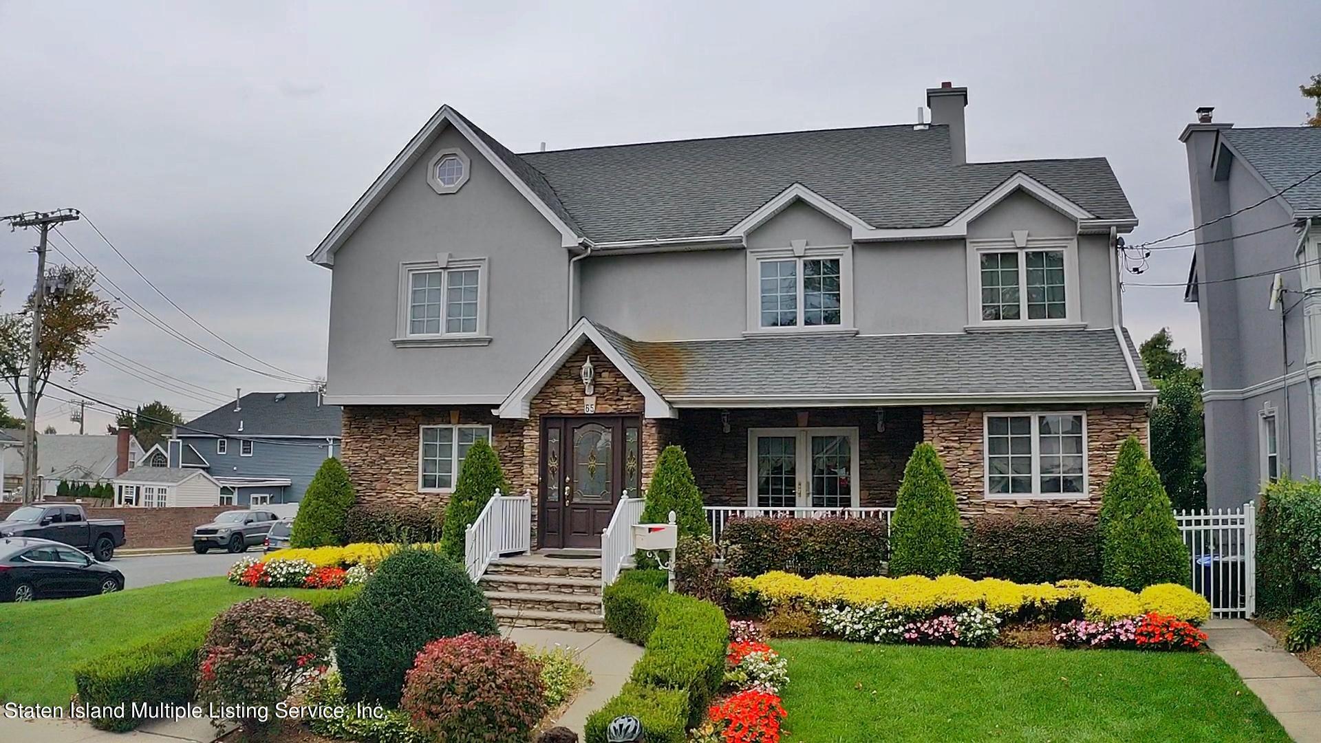 65 Lander Avenue Staten Island, NY 10314 - Photo 4 of 53 a front view of a house with a yard and porch