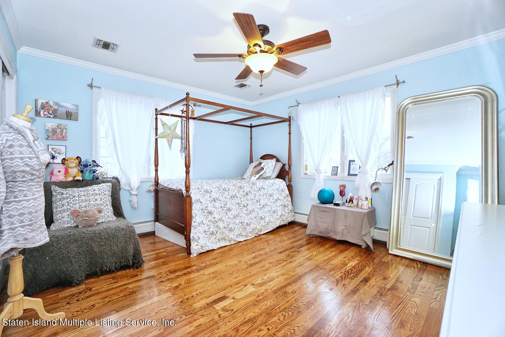 65 Lander Avenue Staten Island, NY 10314 - Photo 41 of 53 a living room with furniture and wooden floor