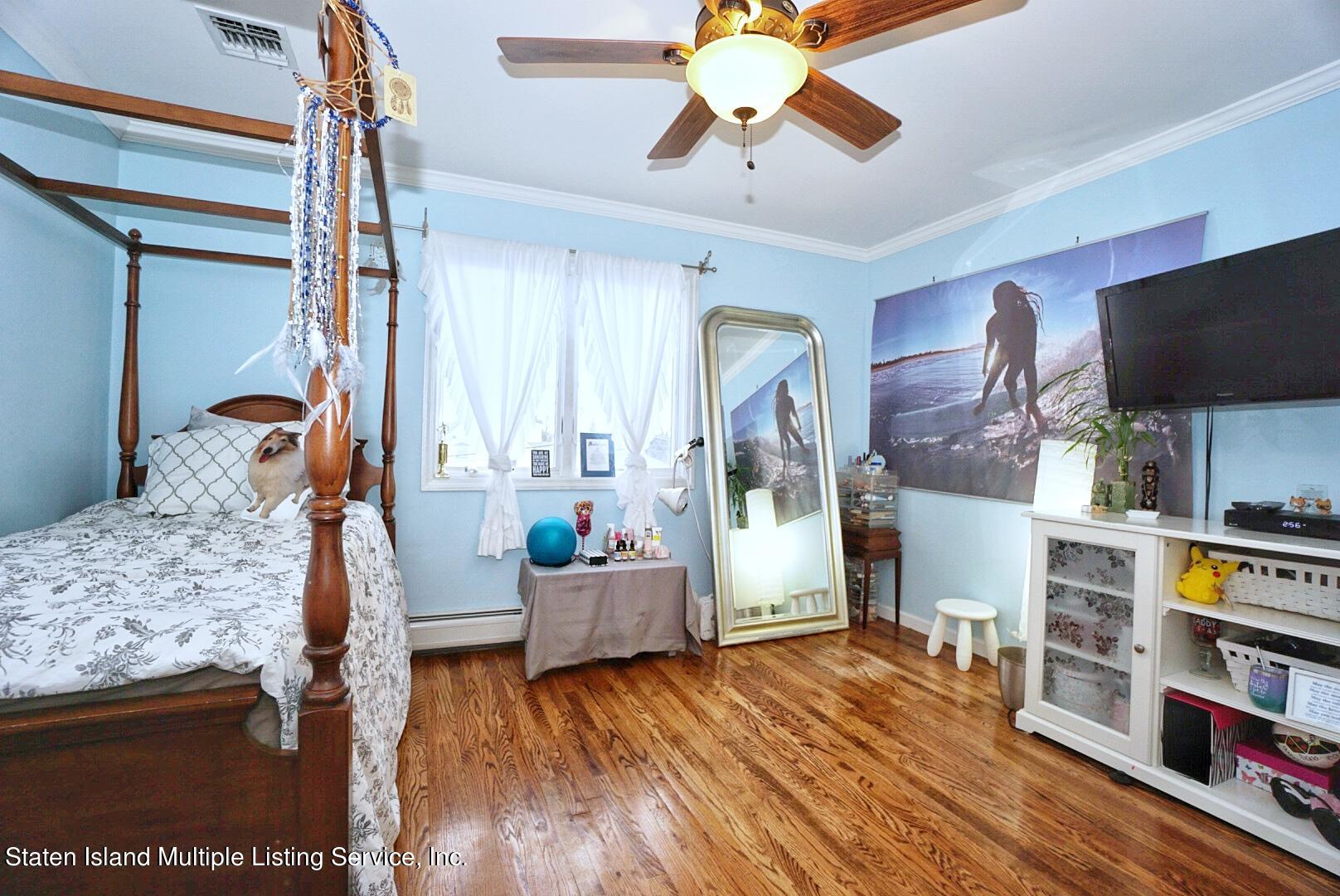 65 Lander Avenue Staten Island, NY 10314 - Photo 43 of 53 a living room with furniture and a wooden floor