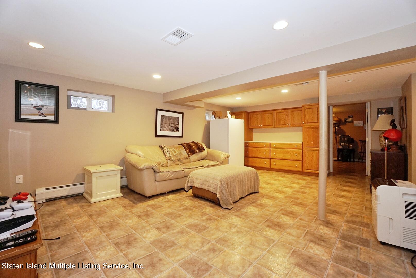 65 Lander Avenue Staten Island, NY 10314 - Photo 45 of 53 a spacious bedroom with a bed and couch
