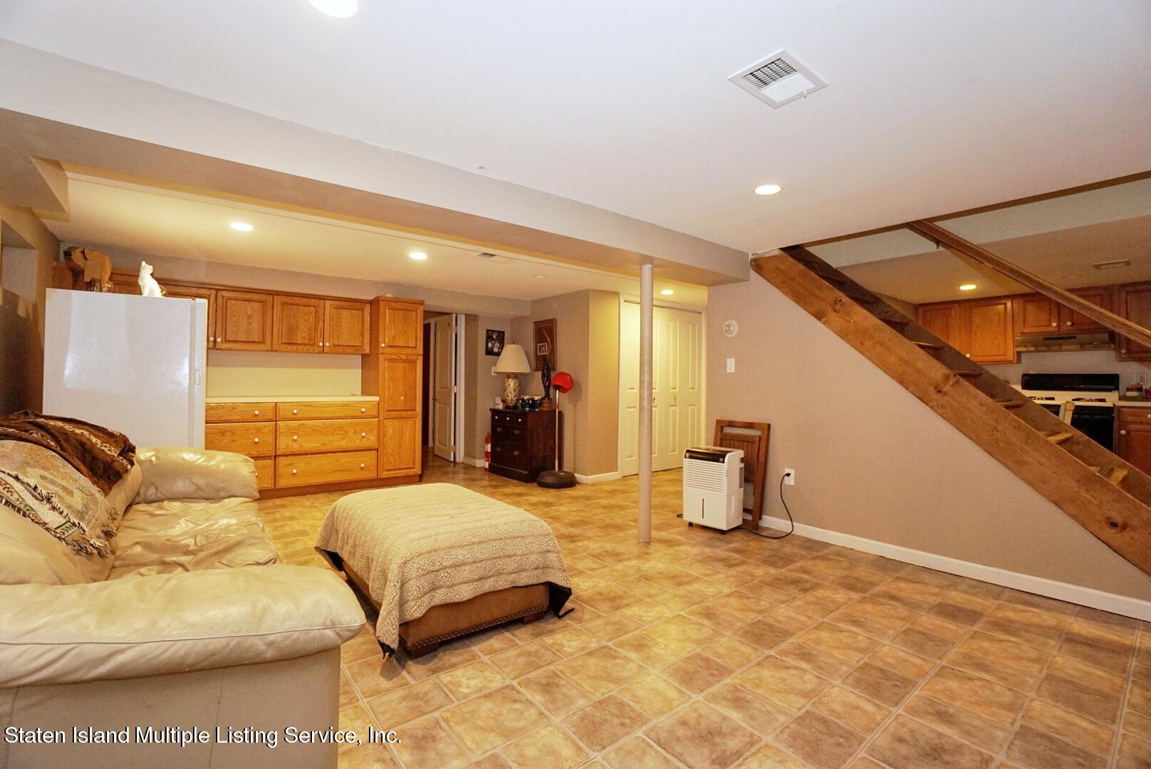 65 Lander Avenue Staten Island, NY 10314 - Photo 49 of 53 a bedroom with furniture and a window