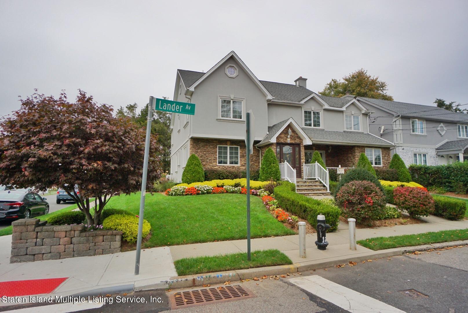 65 Lander Avenue Staten Island, NY 10314 - Photo 5 of 53 a front view of a house with a garden and plants