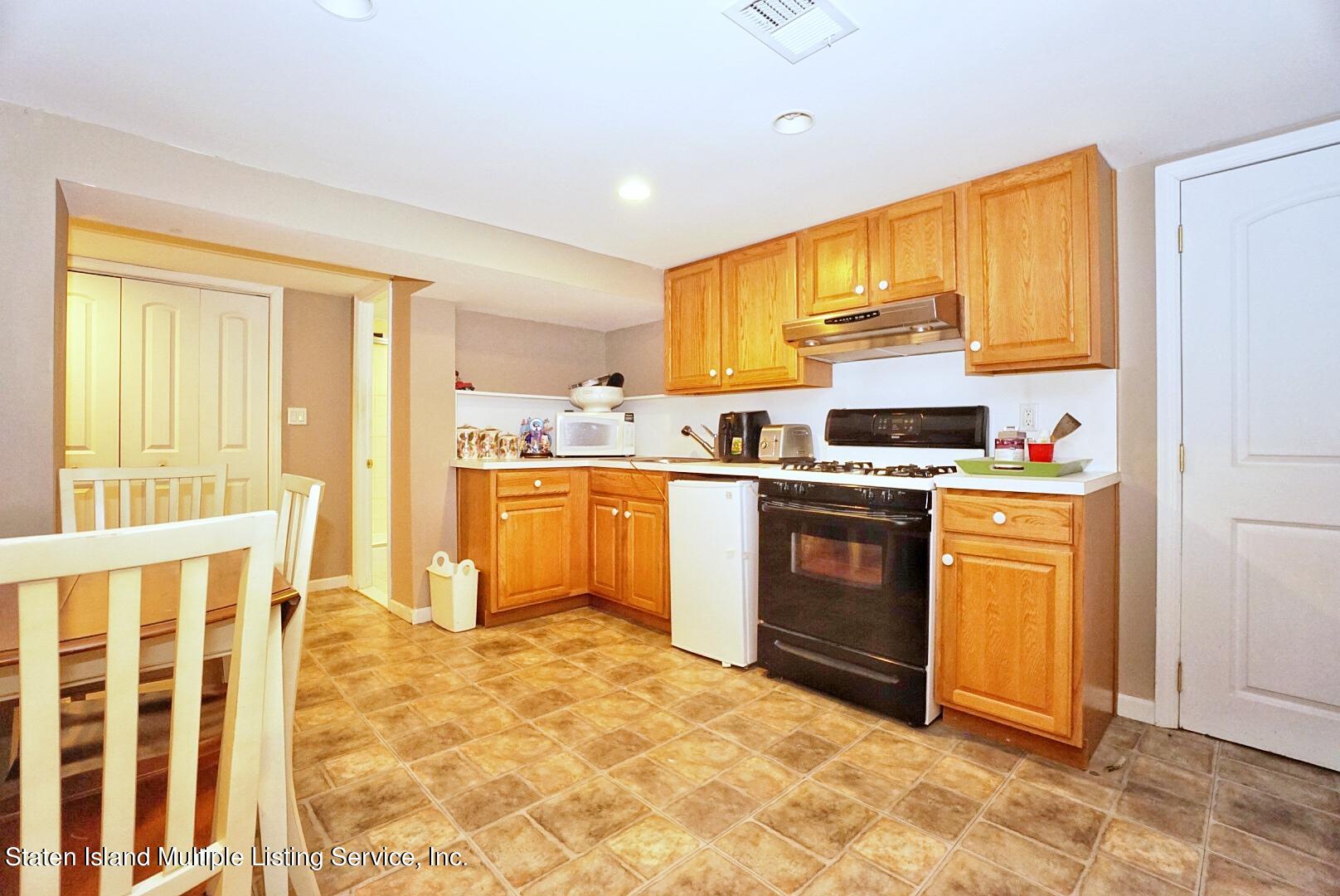 65 Lander Avenue Staten Island, NY 10314 - Photo 51 of 53 a kitchen with stainless steel appliances granite countertop a stove a sink and a refrigerator