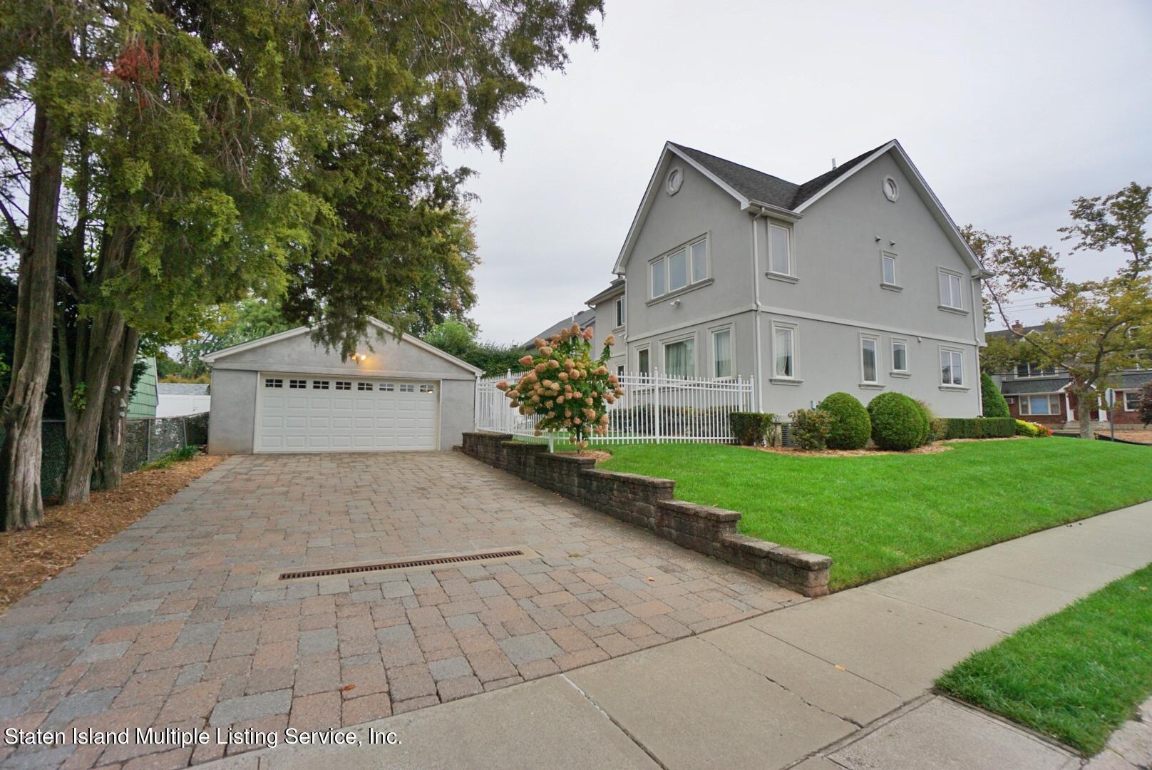 65 Lander Avenue Staten Island, NY 10314 - Photo 6 of 53 a view of a house with a yard and large trees