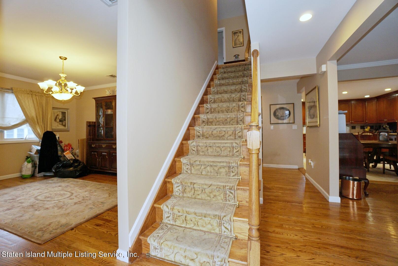 65 Lander Avenue Staten Island, NY 10314 - Photo 10 of 53 a view of a hallway with a dining table and chairs