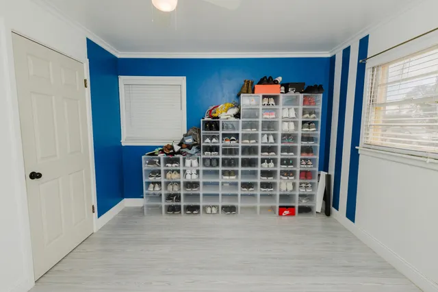 a view of a livingroom with wooden shelves and windows