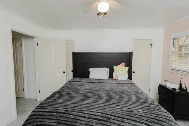 a bedroom with a bed and a chandelier