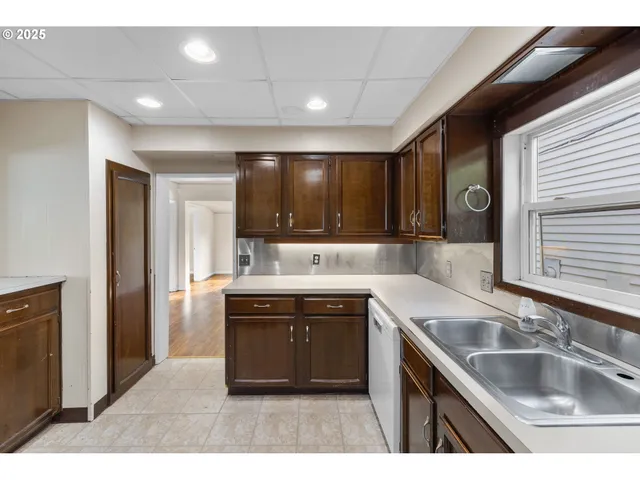 a kitchen with stainless steel appliances granite countertop a sink stove and cabinets