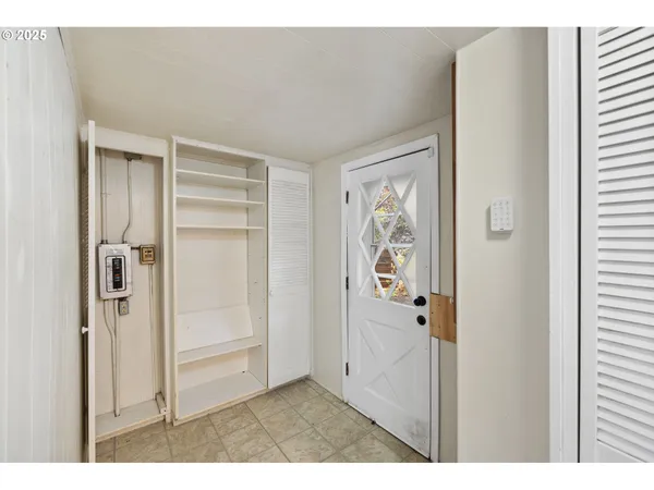 a view of a hallway with wooden floor and closet area