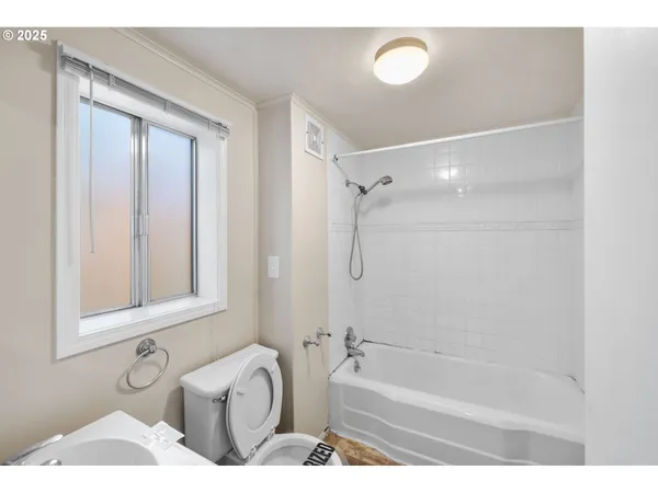 a bathroom with a tub a sink and a shower