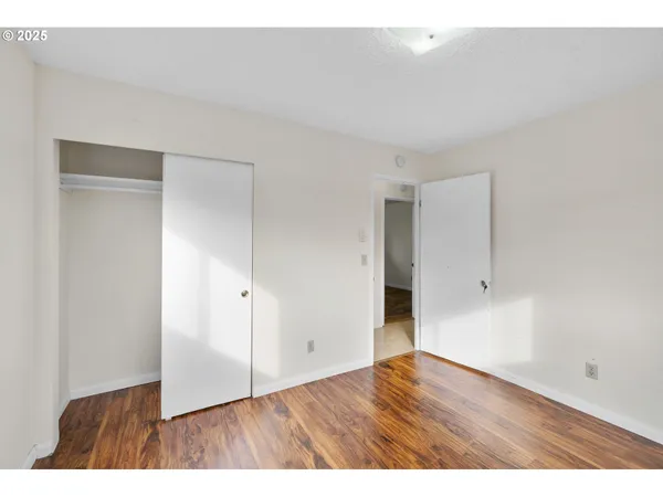 a view of an empty room and wooden floor