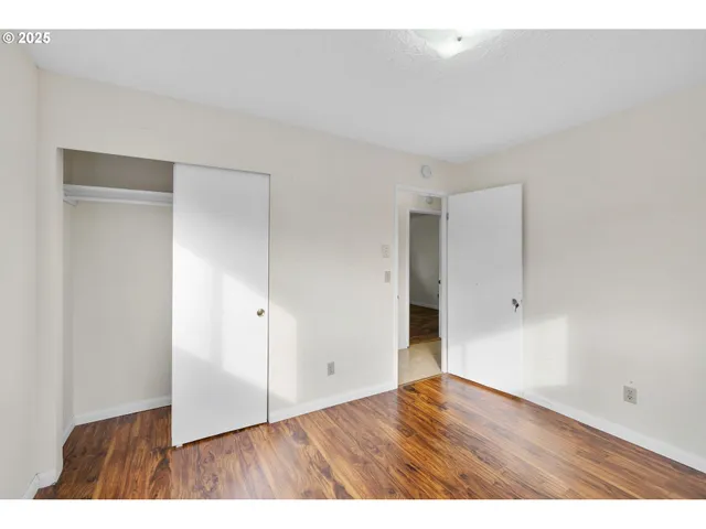 a view of an empty room and wooden floor