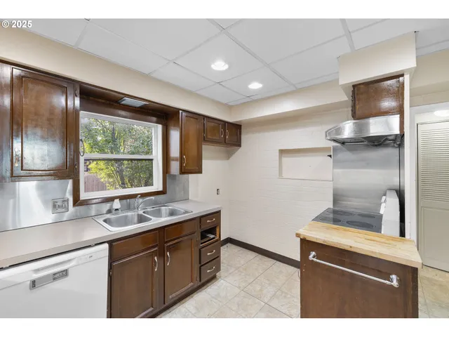 a kitchen with a sink stove and refrigerator