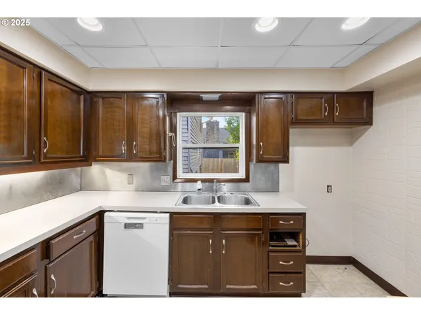 a kitchen with a sink cabinets and window