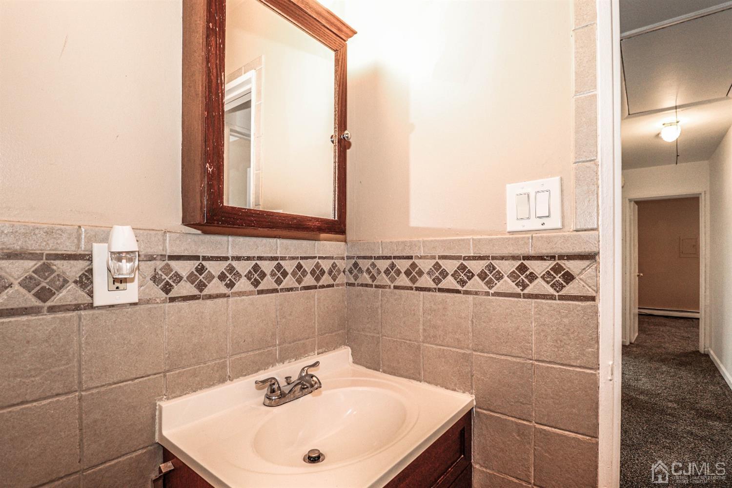 17 Dayton Road Edison, NJ 08817 - Photo 12 of 25 a bathroom with a sink and a mirror