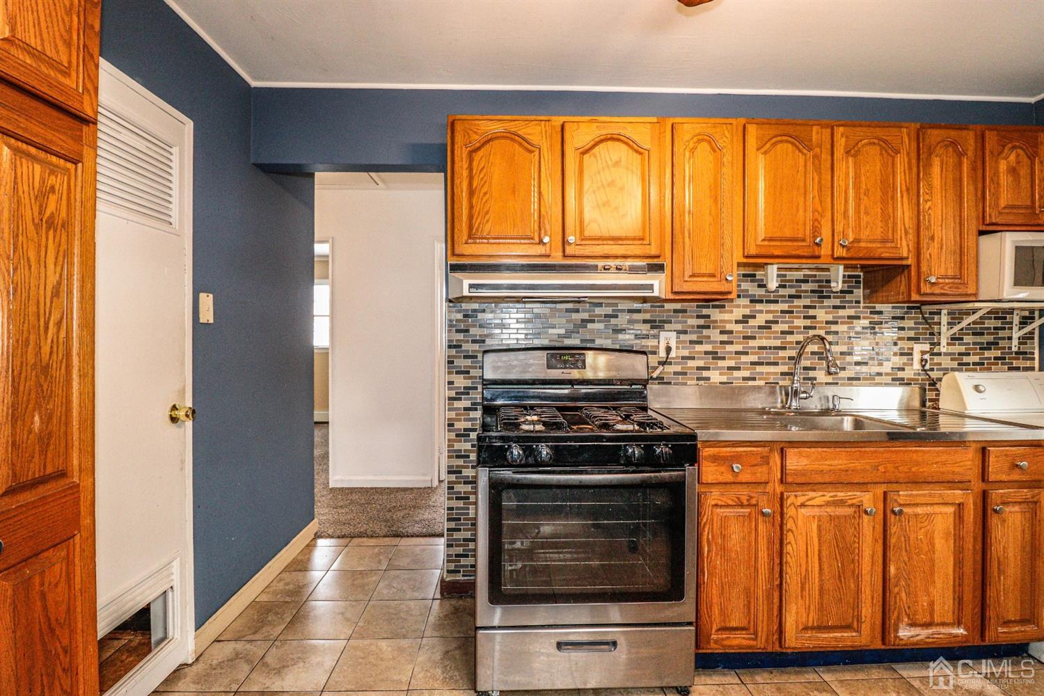 17 Dayton Road Edison, NJ 08817 - Photo 8 of 25 a kitchen with stainless steel appliances granite countertop a stove and a microwave