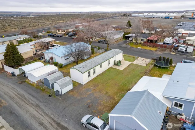 an aerial view of a house with yard swimming pool and ocean view