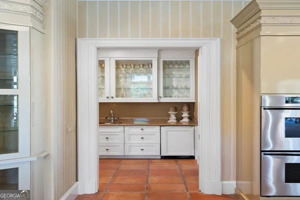 a kitchen with stainless steel appliances kitchen island granite countertop a stove and a view of living room