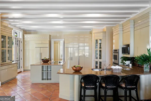 a view of a patio with table and chairs and potted plants