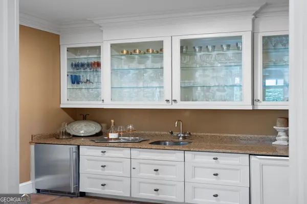 a living room with furniture fireplace and palm tree