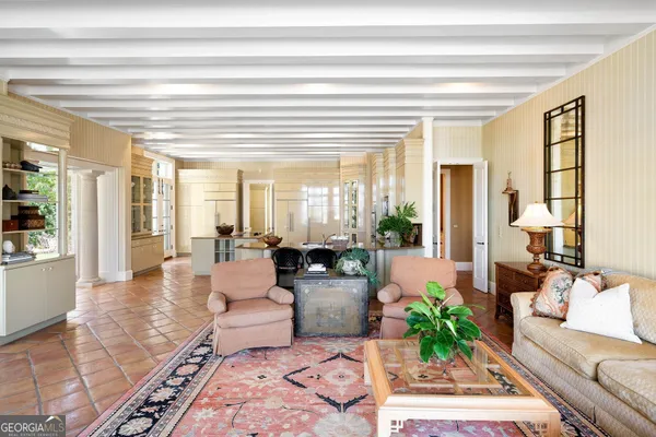 a bedroom with furniture and a large window