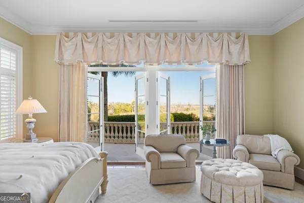 a bedroom with a bed and a couch next to a window